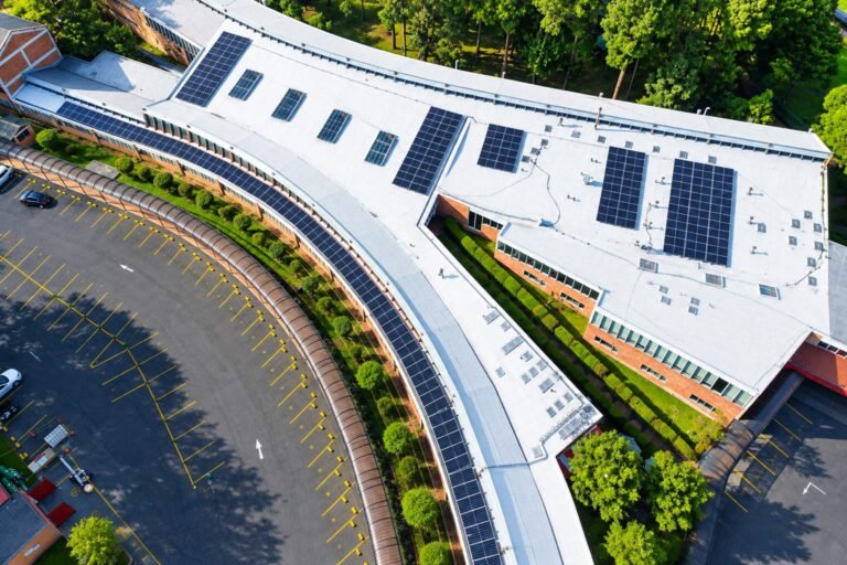 Técnico con arnés instalando paneles solares en una azotea de Bogotá